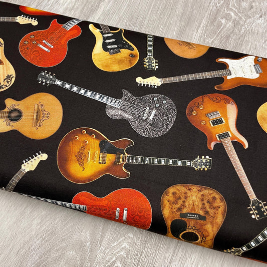 Tossed Guitars Fabric on black - Timeless Treasures