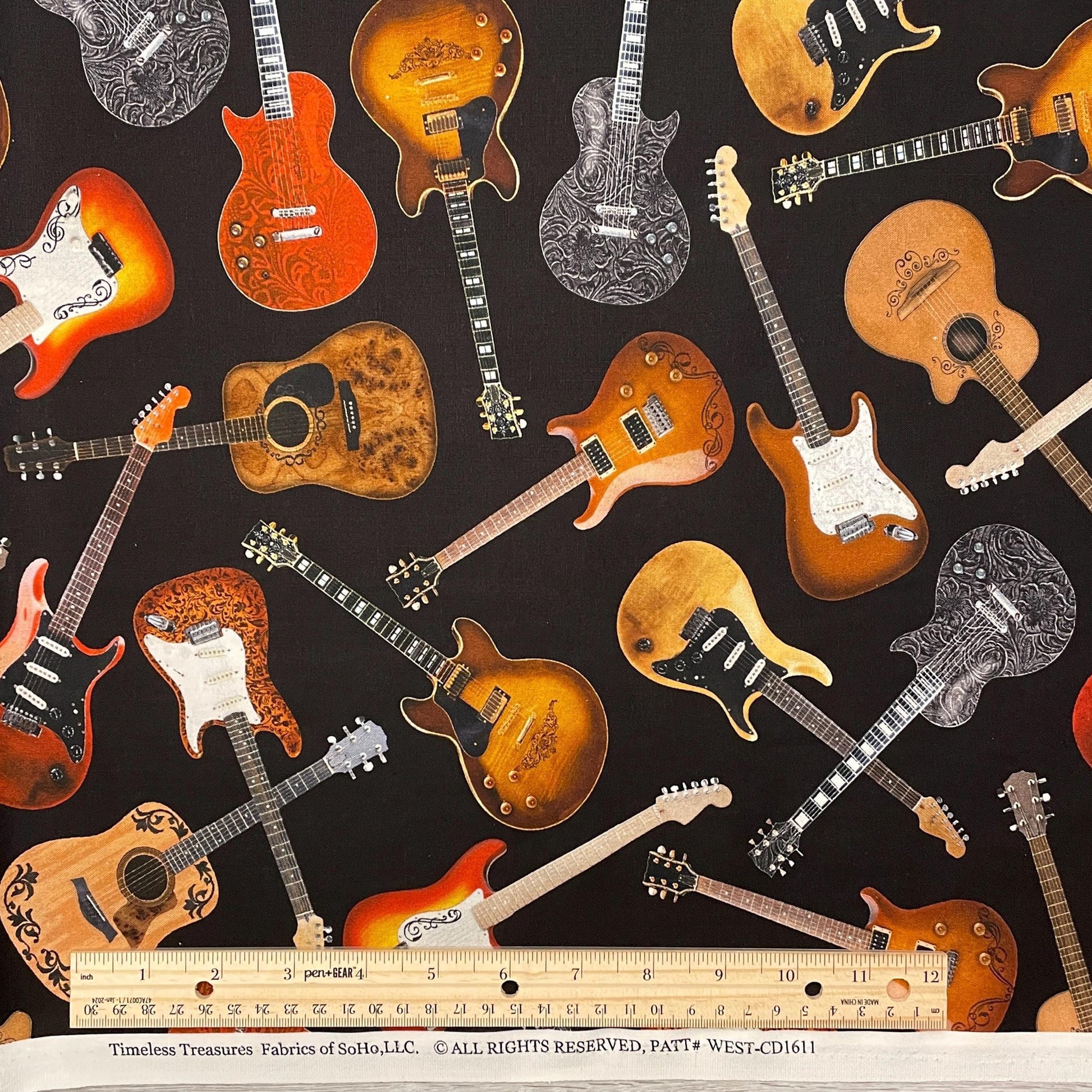Tossed Guitars Fabric on black - Timeless Treasures