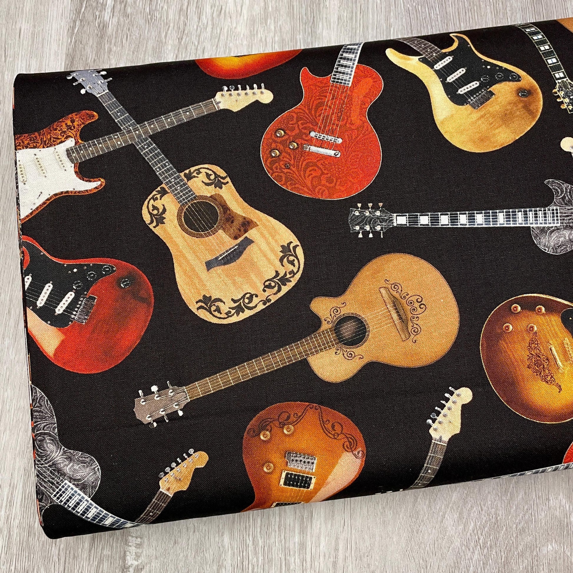 Tossed Guitars Fabric on black - Timeless Treasures